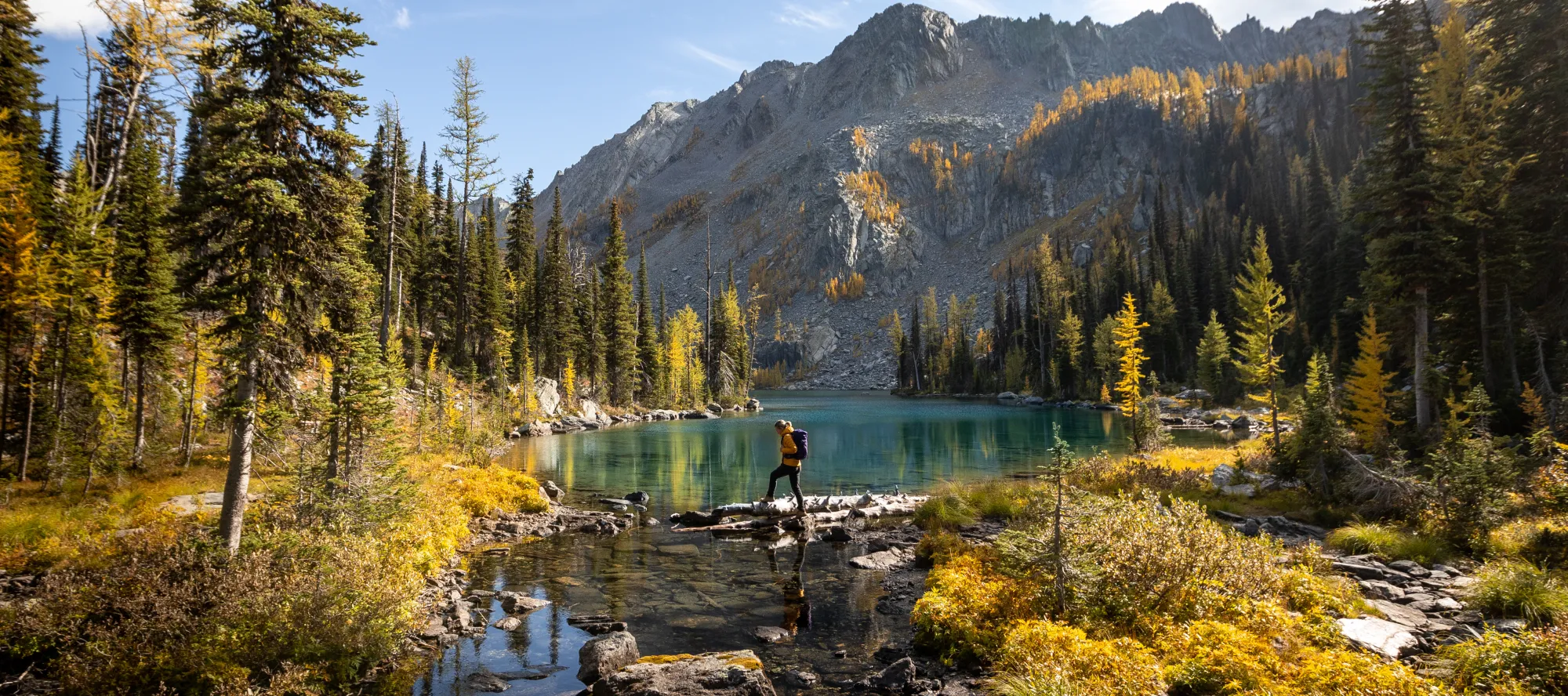 Fall hiking by a lake with larches, Cranbrook BC